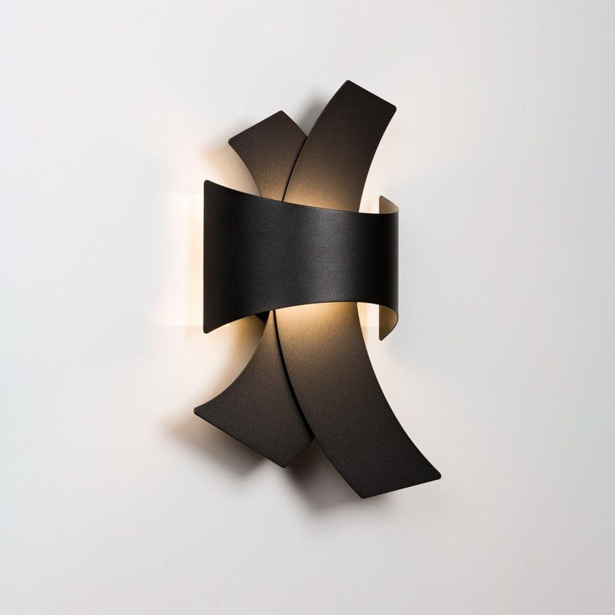 Front view of a sculptural wall lamp combining premium materials with contemporary design.