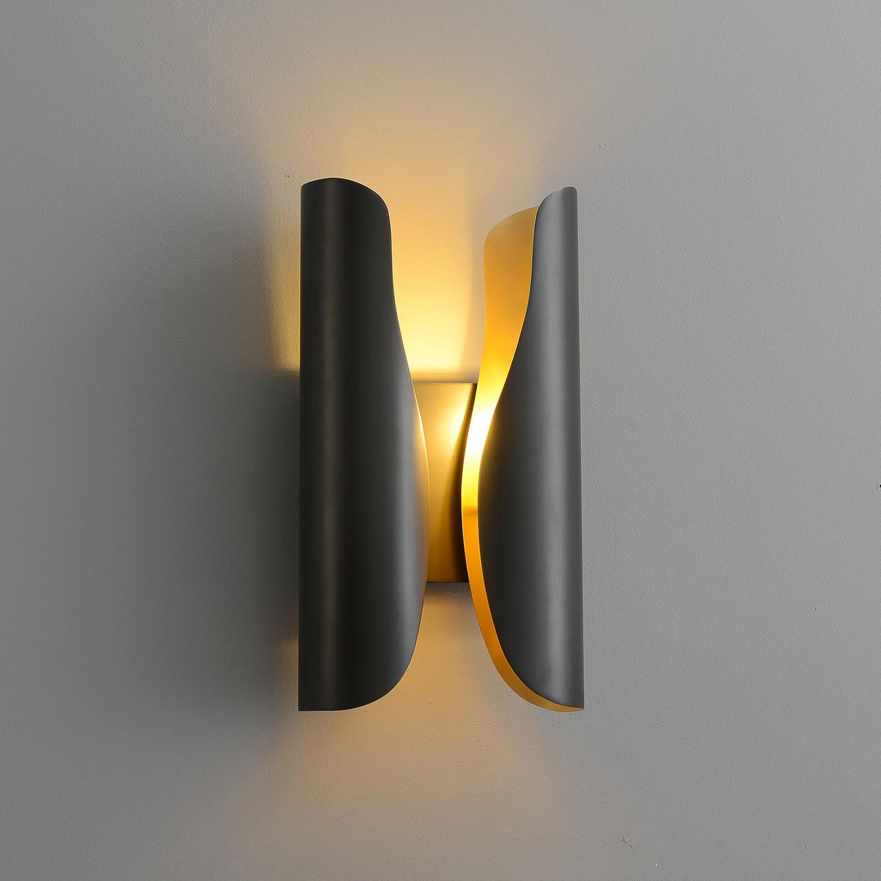 Front view of a sculptural wall lamp combining premium materials with contemporary design.