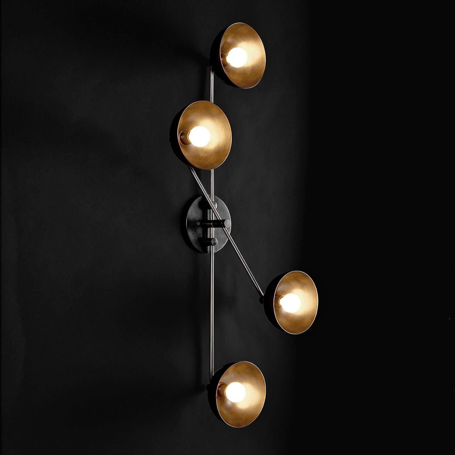 Front view of a sculptural wall lamp combining premium materials with contemporary design.