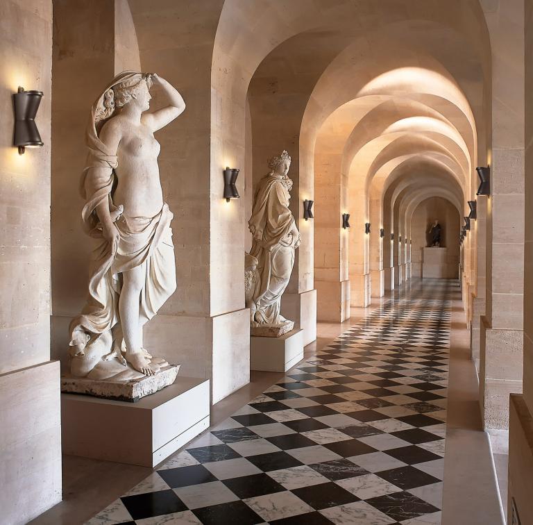Sculptural wall lamp installed in a luxury hotel lobby creating an architectural focal point.