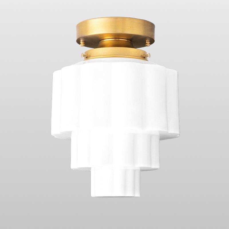 Art Deco ceiling light with a stepped geometric structure shown from the front on a white background