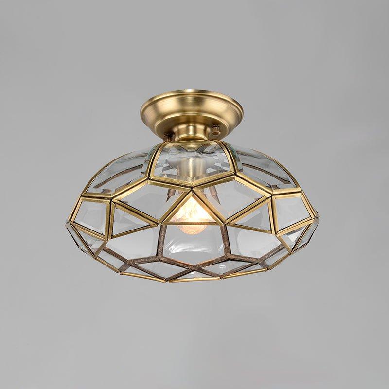 Art Deco ceiling light with a bold black and brass geometric structure on a white background
