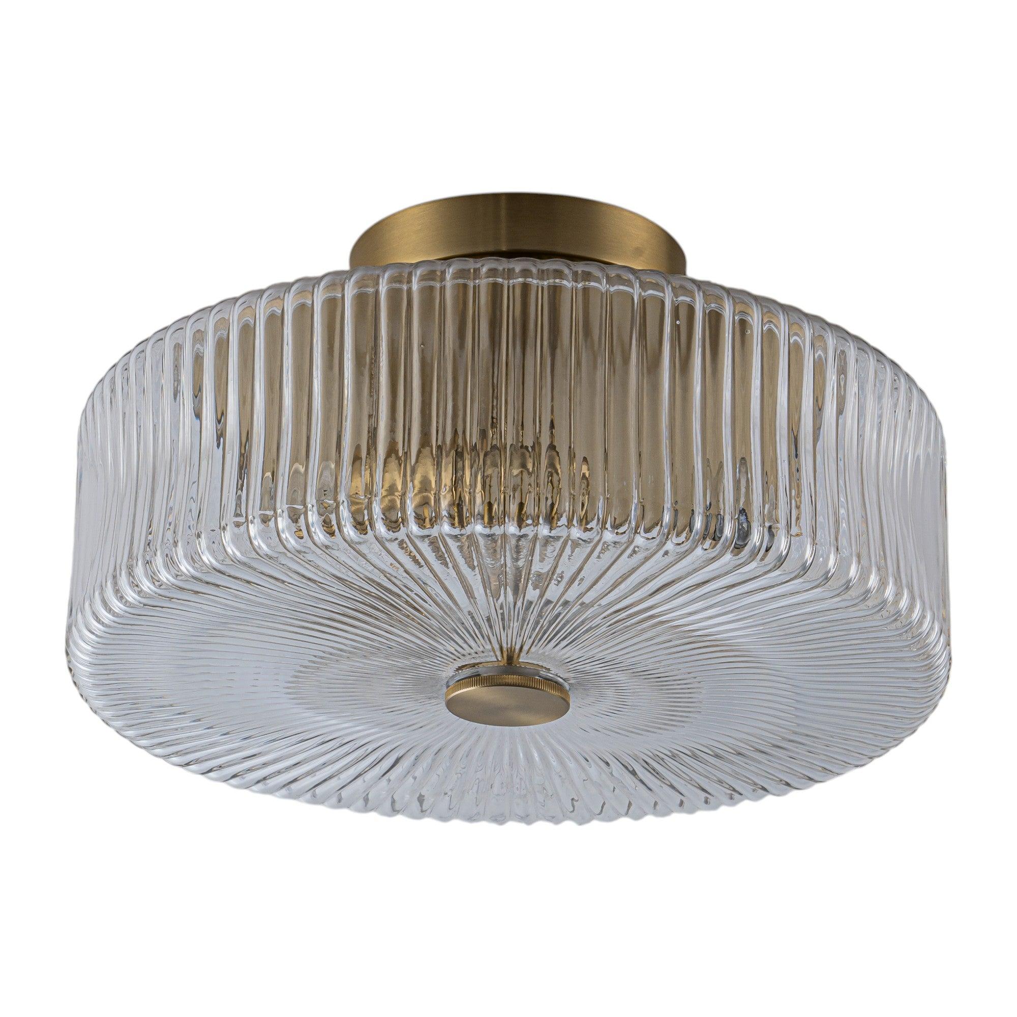 Art Deco ceiling light with ribbed glass and refined brass detailing on a white background