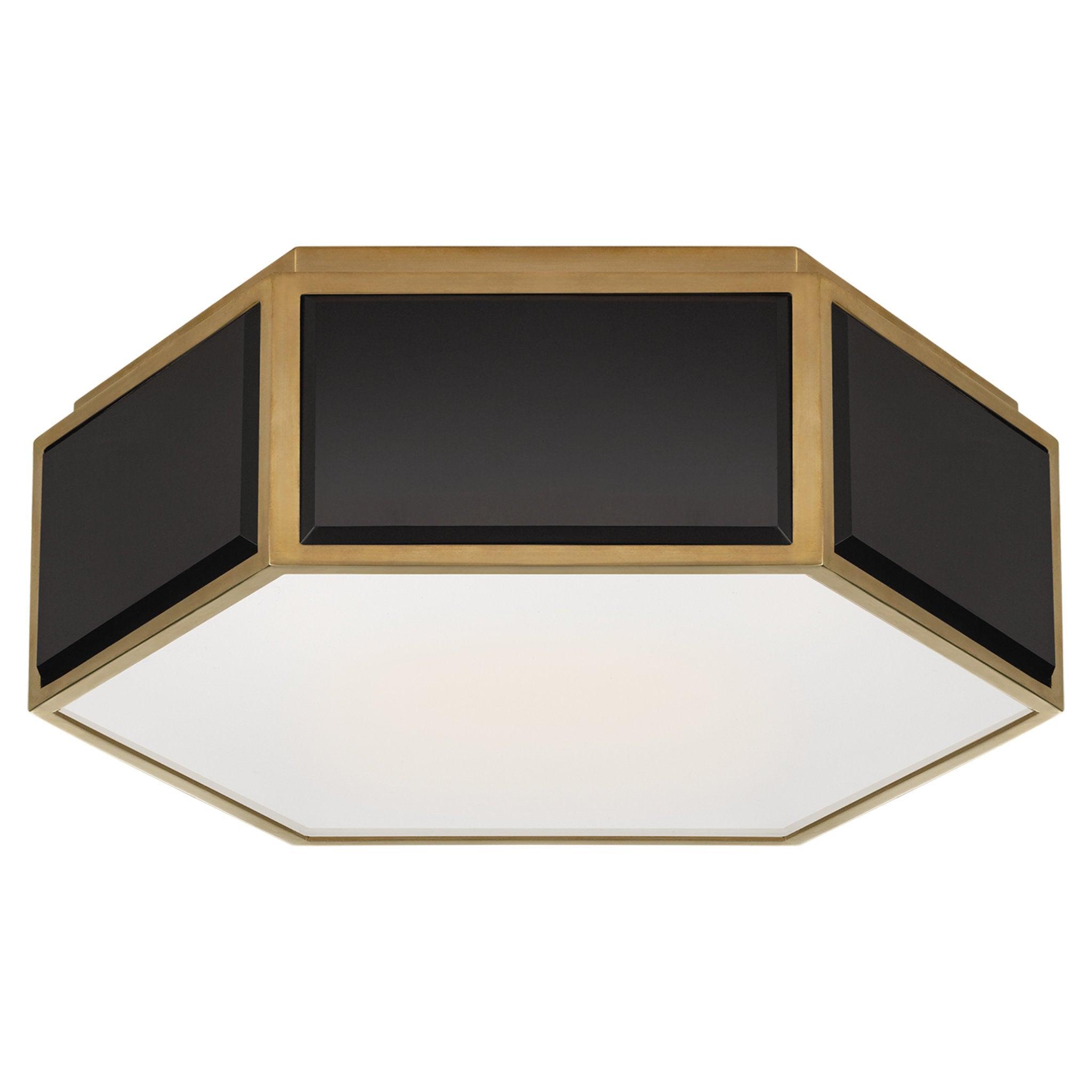 Art Deco ceiling light with a bold black and brass geometric structure on a white background