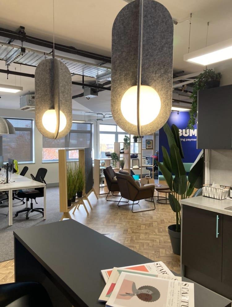 Suspended acoustic office lighting combining functional illumination with sound-absorbing elements for contemporary workplaces