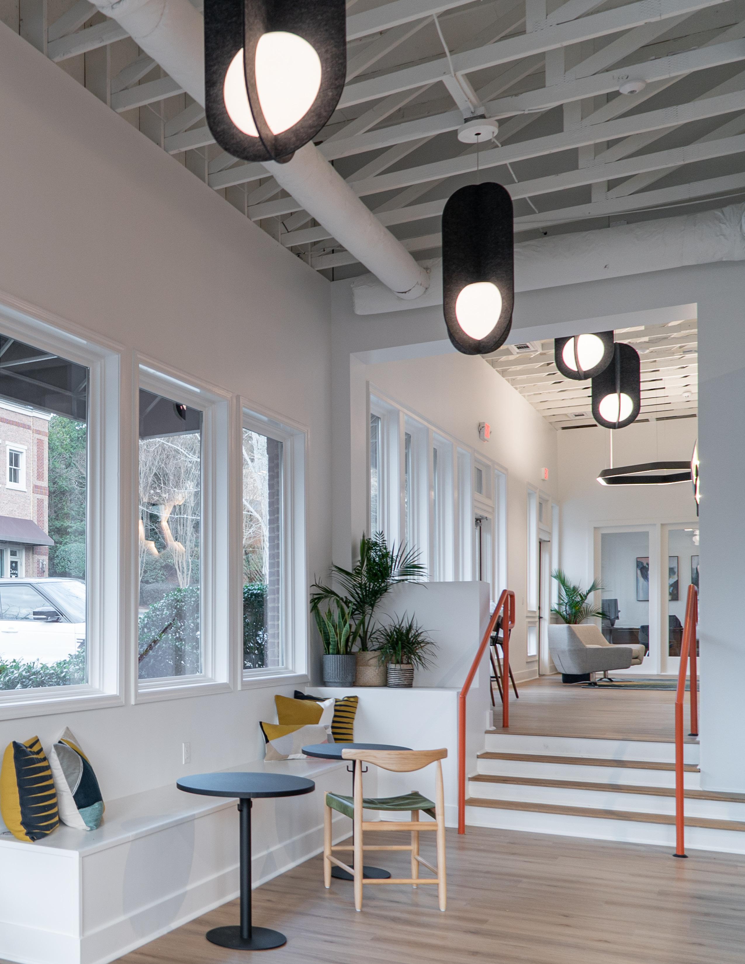 Suspended acoustic office lighting combining functional illumination with sound-absorbing elements for contemporary workplaces