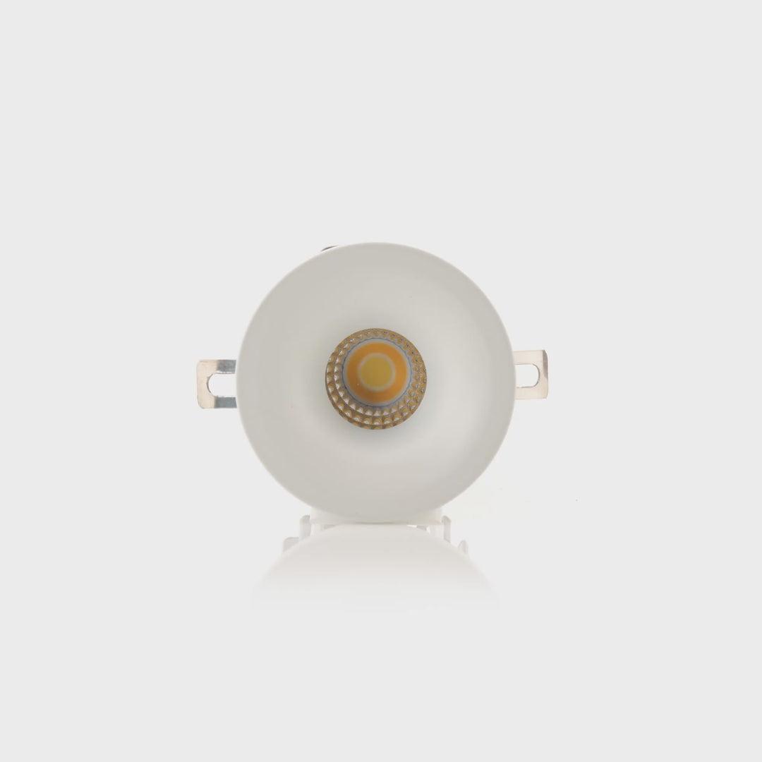 Front view of a compact recessed downlight with a deep anti-glare aperture.