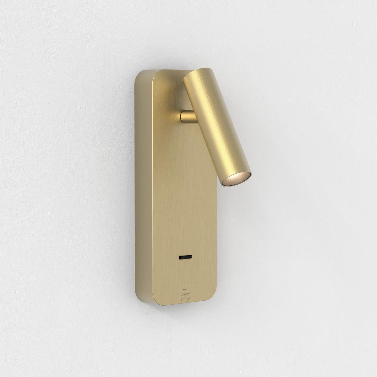 Front view of a reading wall lamp with integrated directional lighting and premium finish.