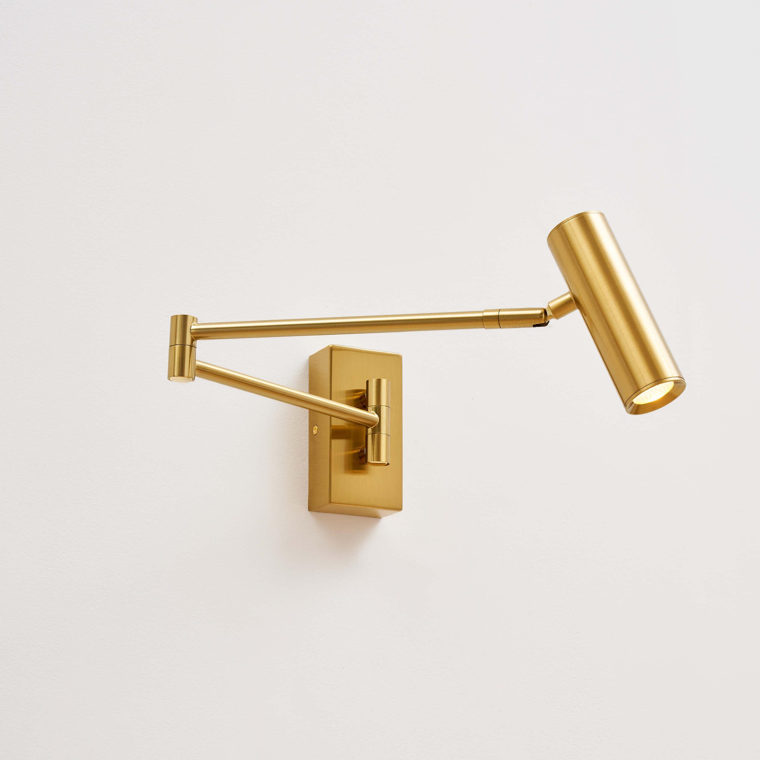 Front view of a reading wall lamp with integrated directional lighting and premium finish.