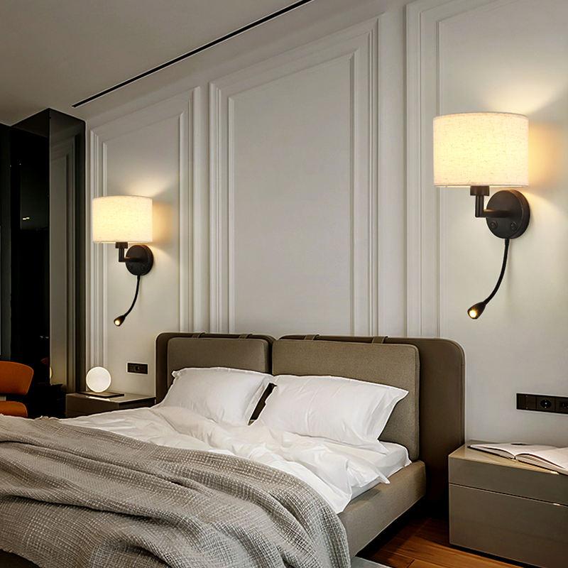 Reading wall lamp installed beside a luxury hotel bed providing comfortable task illumination.