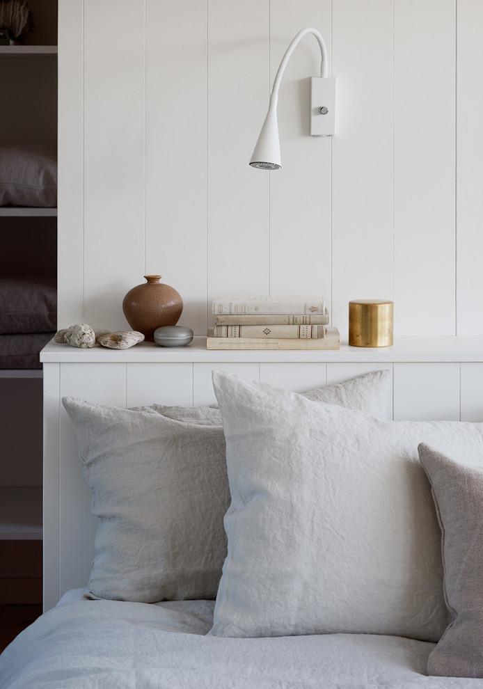 Reading wall lamp installed beside a luxury hotel bed providing comfortable task illumination.