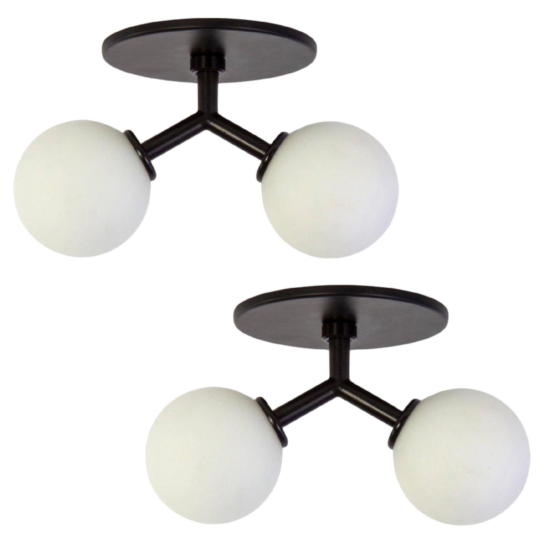 Globe ceiling light collection with spherical opal glass diffusers in different sizes