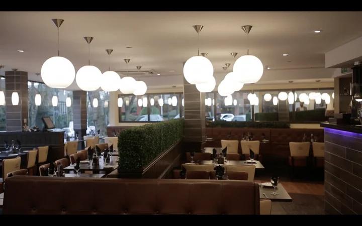 Globe ceiling lights integrated into a refined boutique hospitality interior