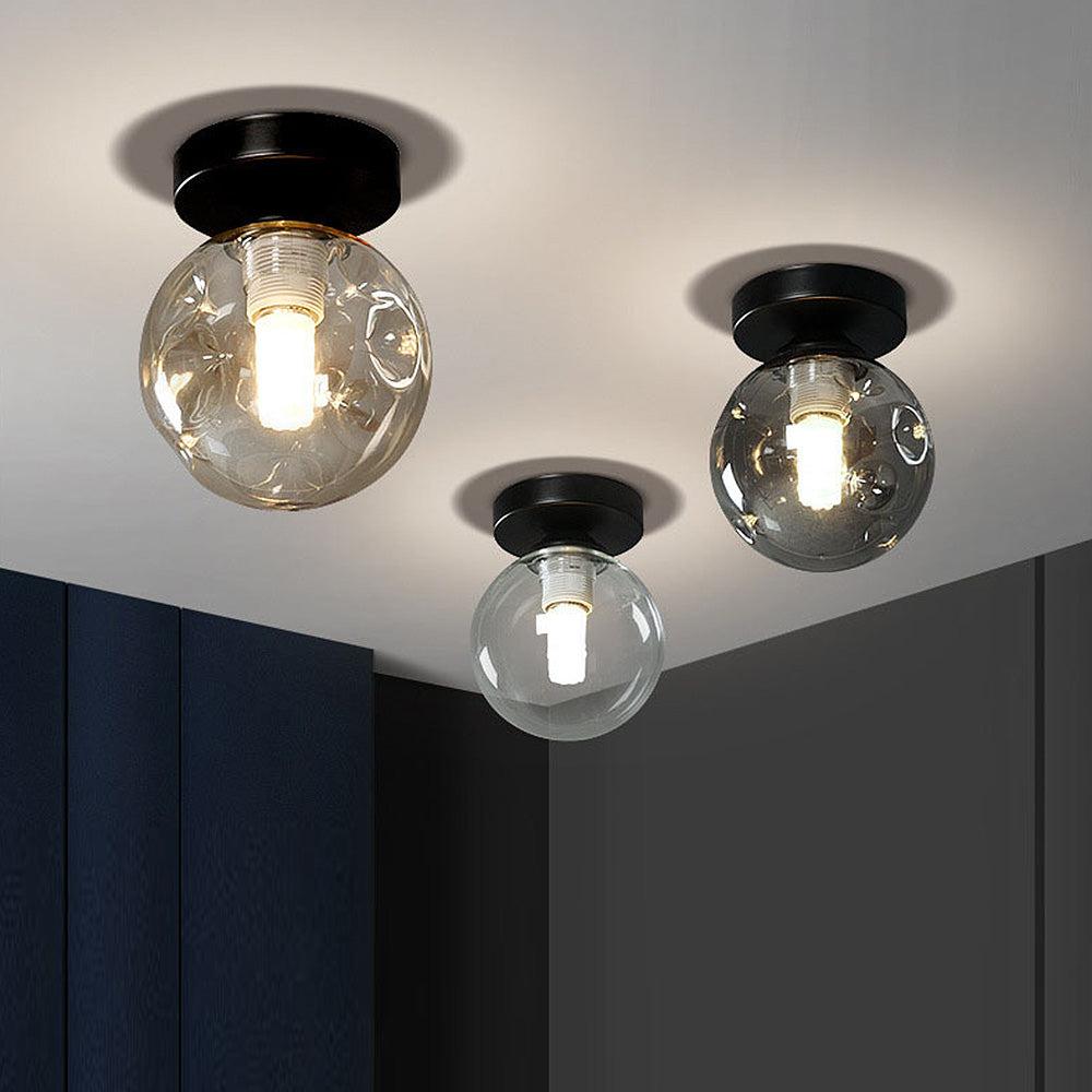 Globe ceiling light collection with spherical opal glass diffusers in different sizes