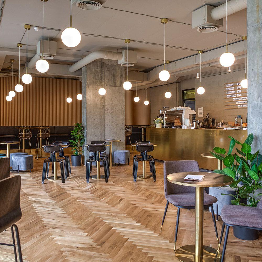 Globe ceiling lights integrated into a refined boutique hospitality interior