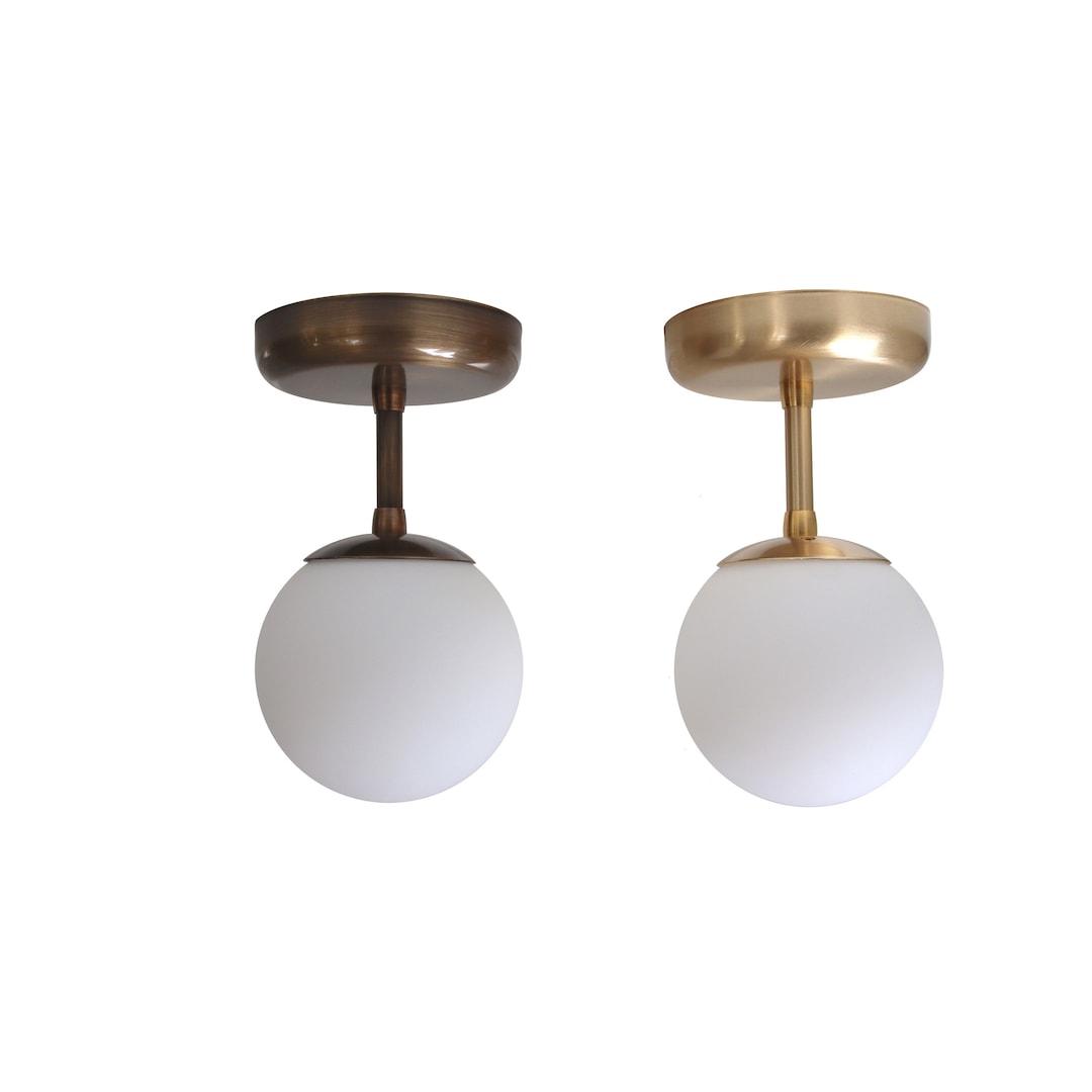 Globe ceiling light collection with spherical opal glass diffusers in different sizes