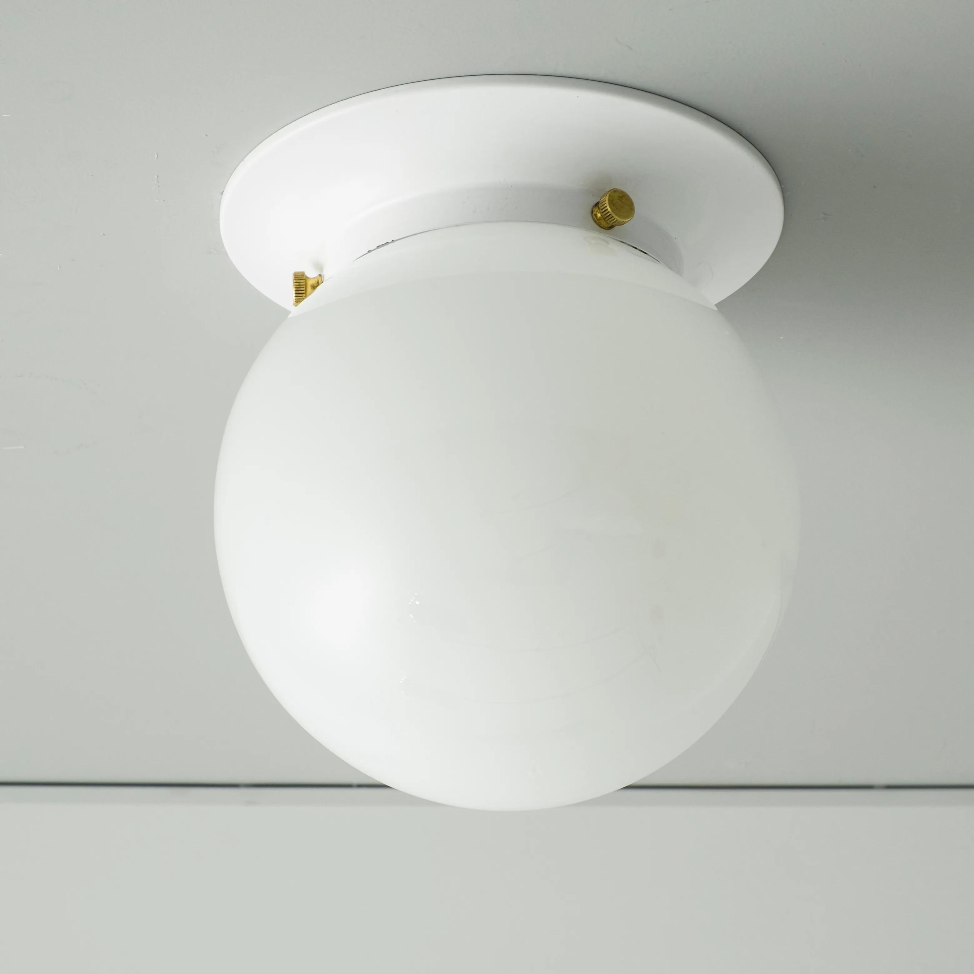Front view of a white opal glass globe ceiling light