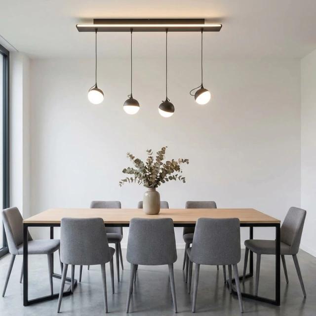 Minimal pendant lights installed above a contemporary dining table in a modern interior.
