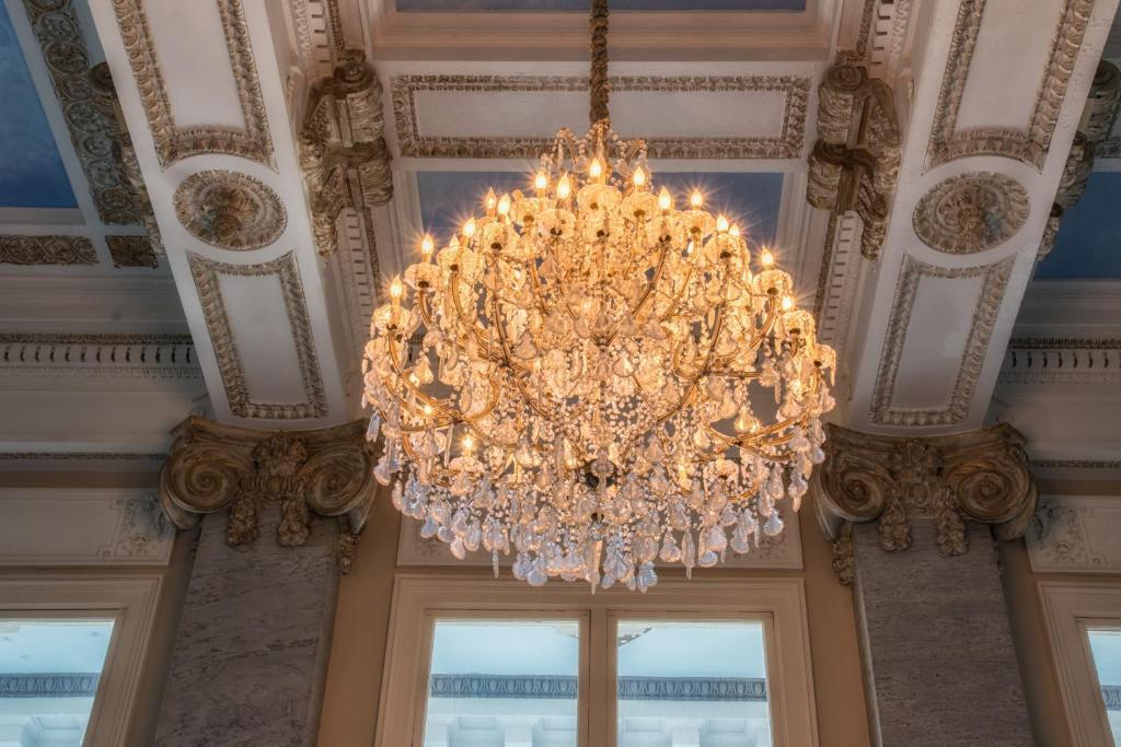 Classic chandelier installed in a prestigious historic hospitality interior.