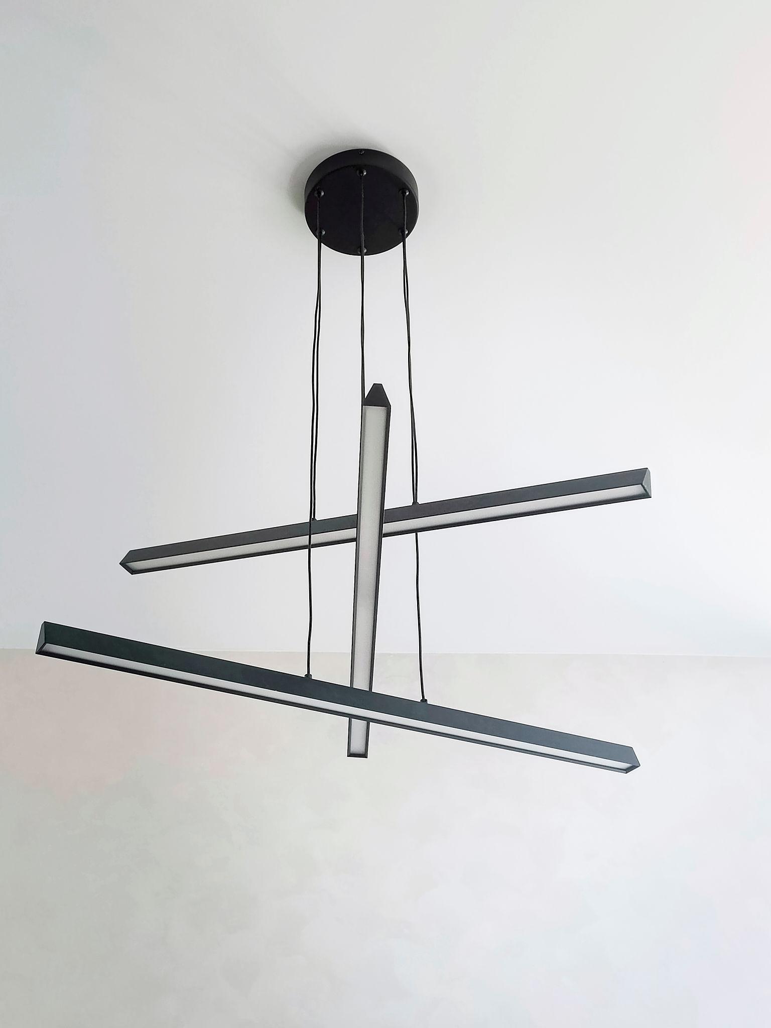 Front view of a minimalist chandelier with slim geometric lines.