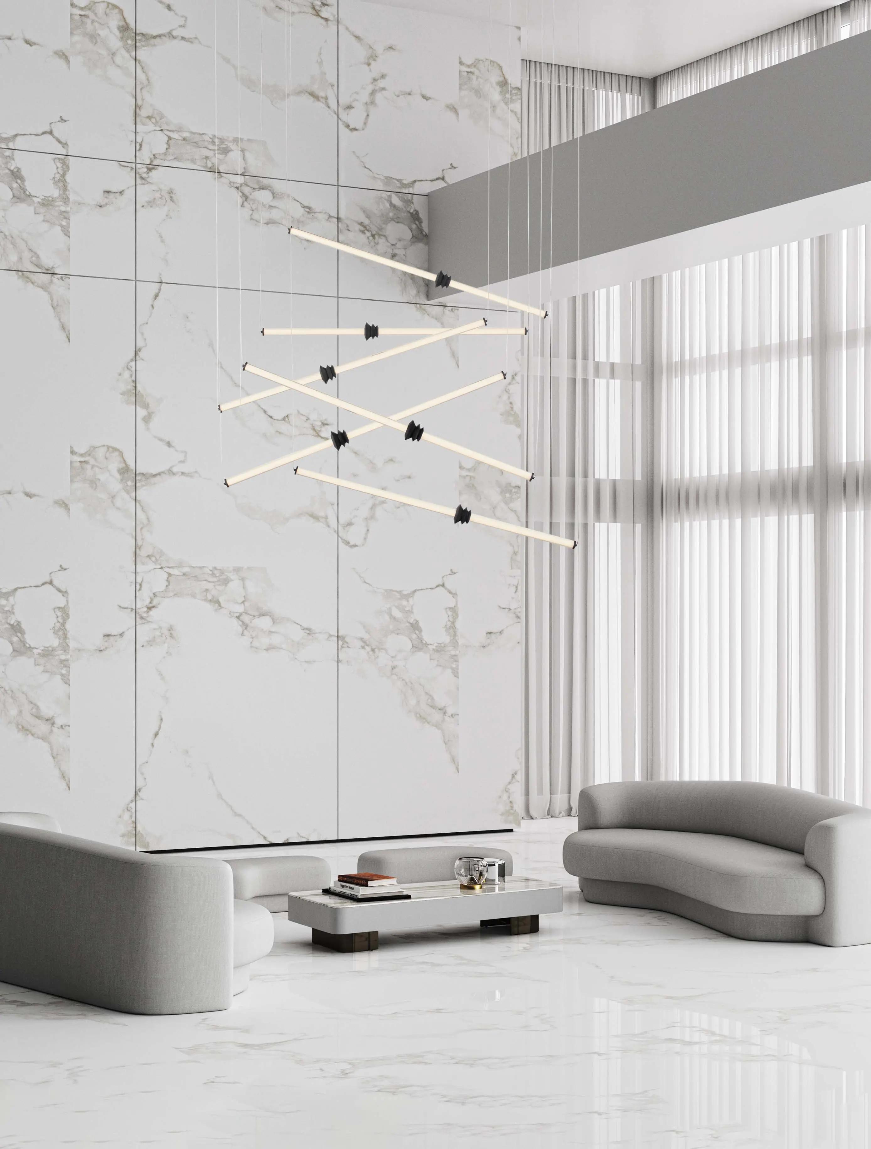 Minimal chandelier installed above a contemporary dining area in a premium architectural interior.