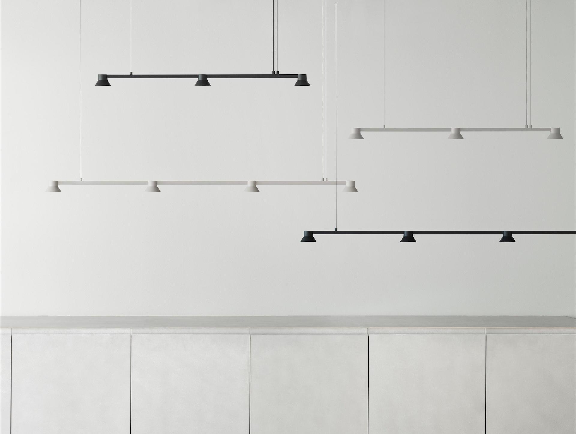 Minimal chandelier family featuring multiple sizes and linear configurations.