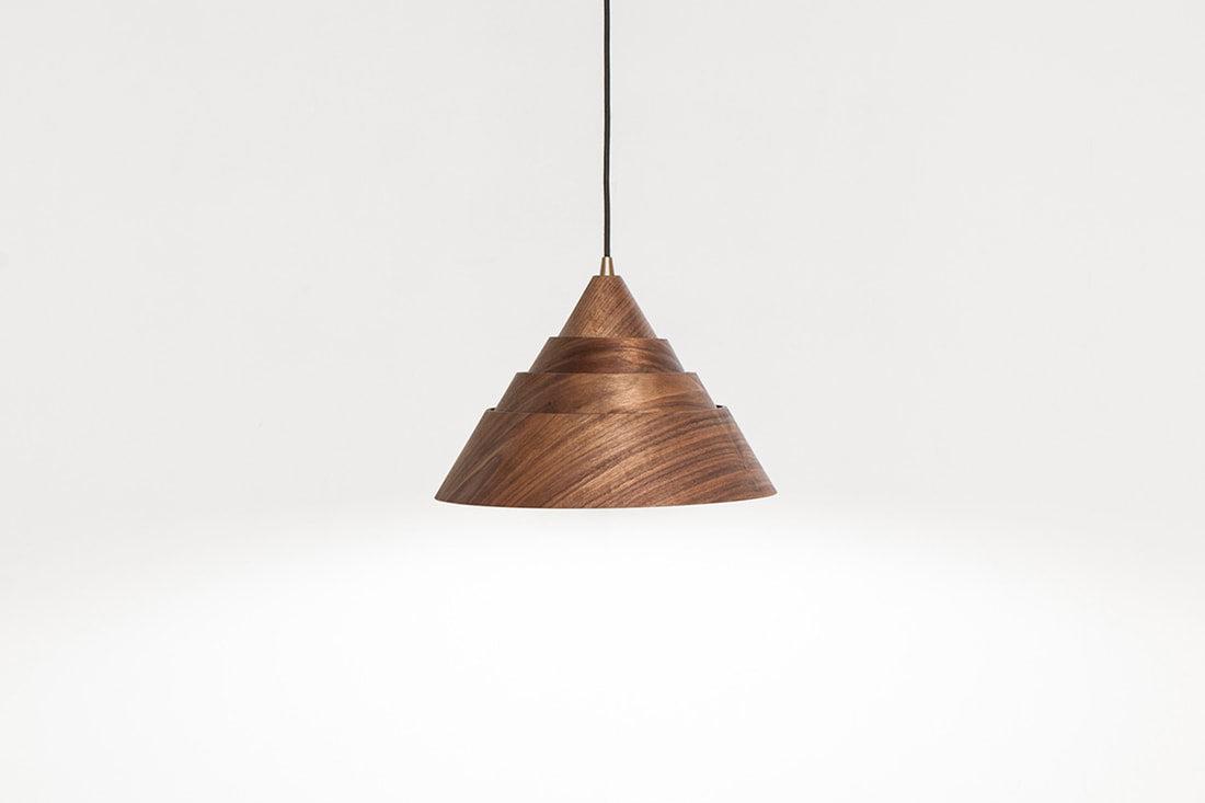 Front view of a decorative wooden pendant light for architectural interiors.