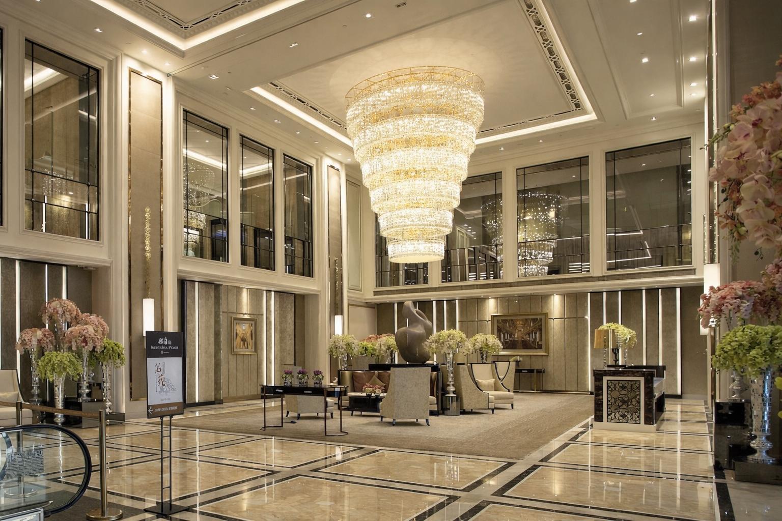 Crystal chandelier installed in a luxury hotel lobby with premium architectural design.