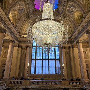 Crystal chandelier installed in a luxury hotel lobby with premium architectural design.