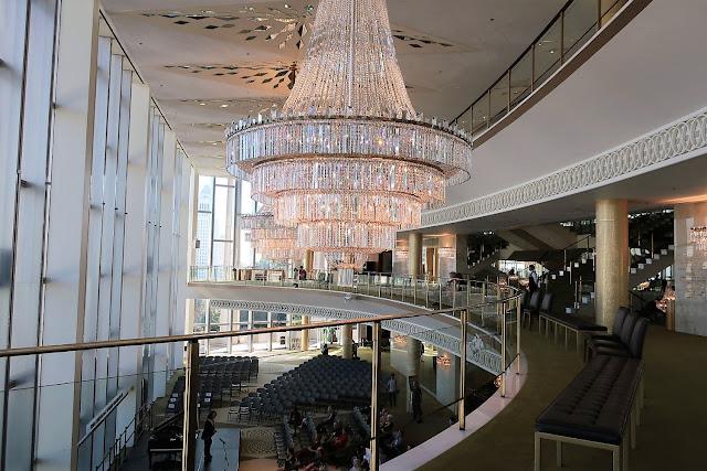 Crystal chandelier installed in a luxury hotel lobby with premium architectural design.