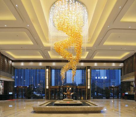 Crystal chandelier installed in a luxury hotel lobby with premium architectural design.