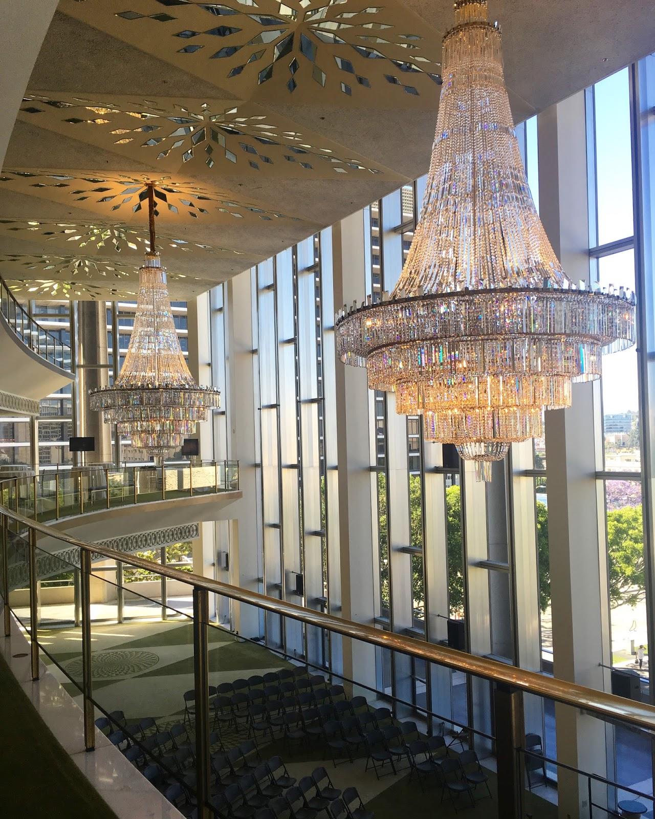 Crystal chandelier installed in a luxury hotel lobby with premium architectural design.