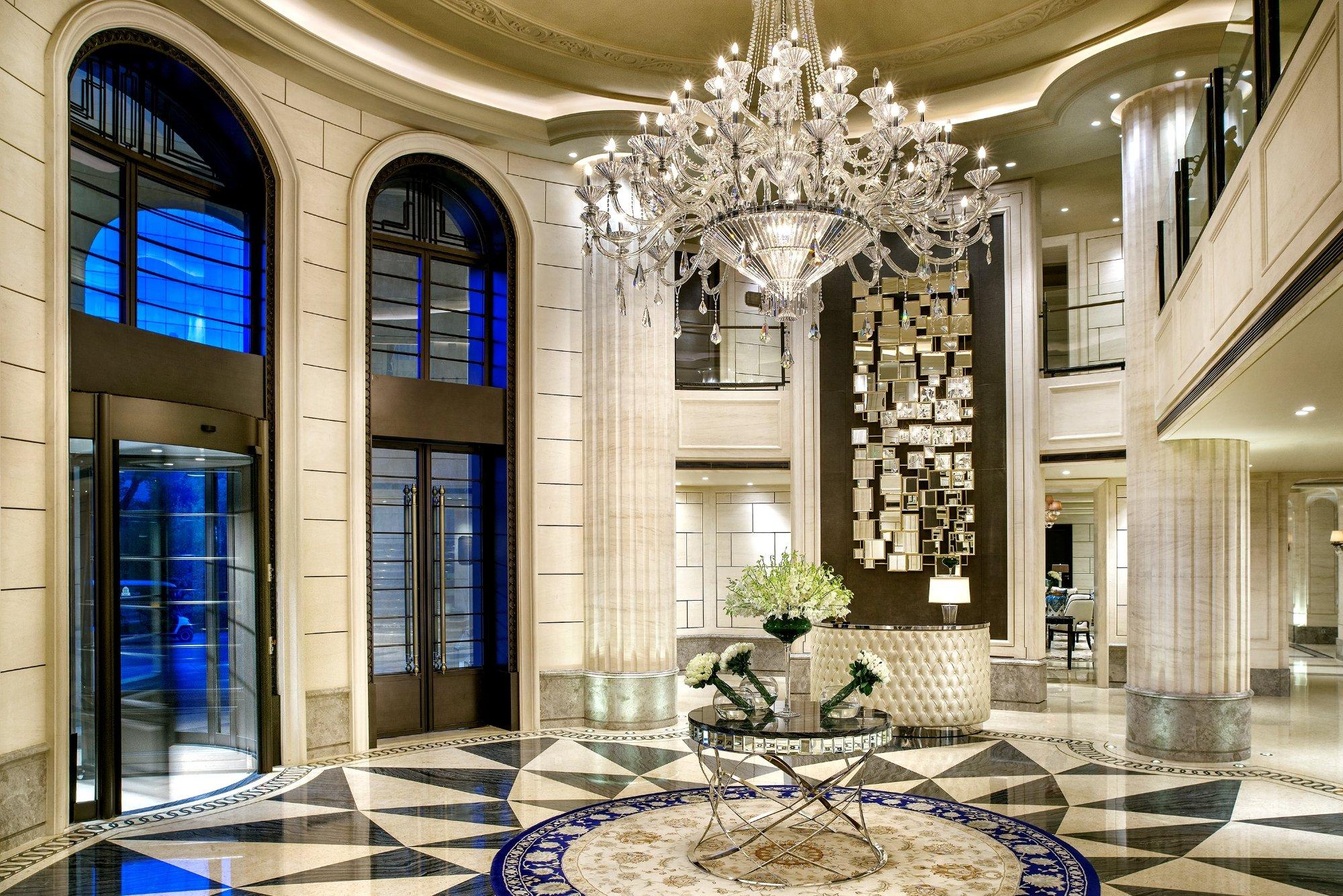 Crystal chandelier installed in a luxury hotel lobby with premium architectural design.