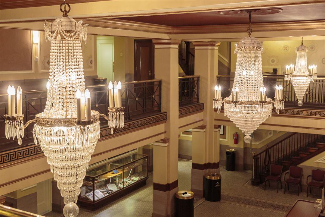 Crystal chandelier installed in a luxury hotel lobby with premium architectural design.