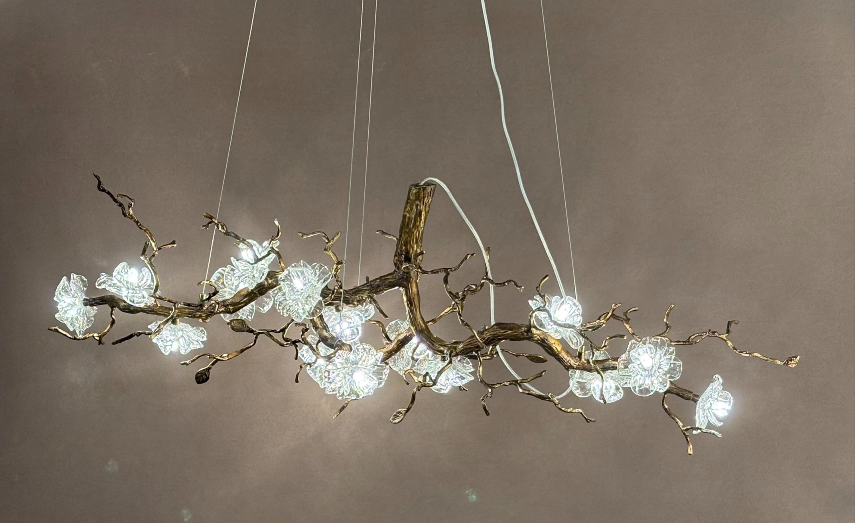 Front view of a sculptural organic chandelier with flowing contemporary forms.