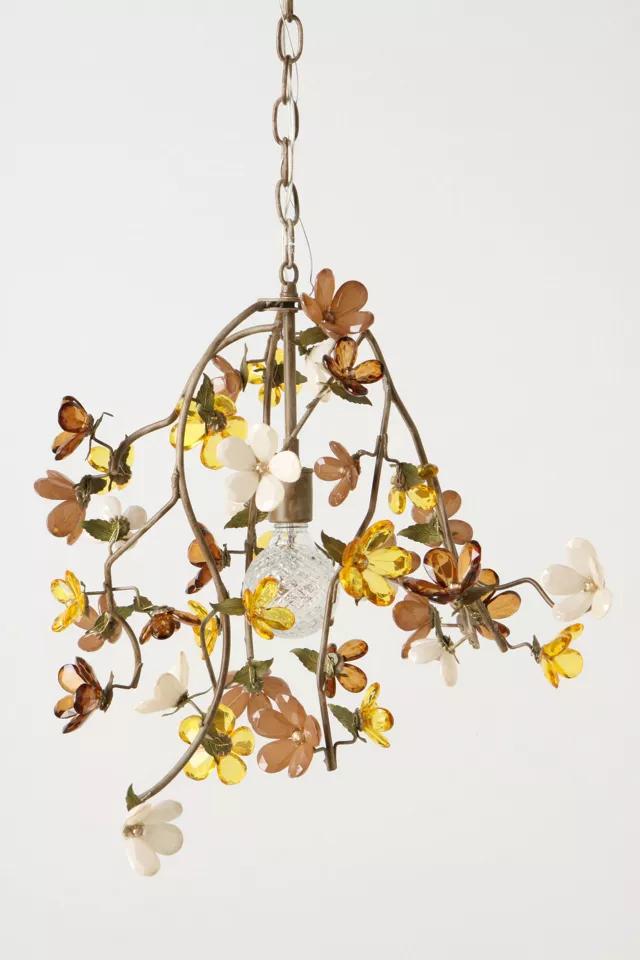 Front view of a sculptural organic chandelier with flowing contemporary forms.
