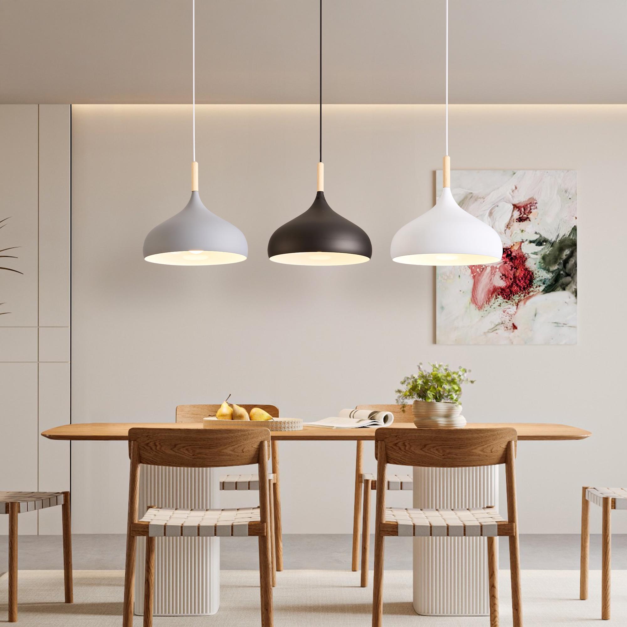 Scandinavian pendant lights installed above a contemporary Nordic-style dining area.