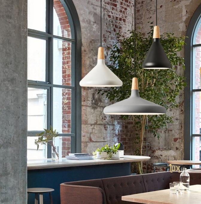 Scandinavian pendant lights installed above a contemporary Nordic-style dining area.