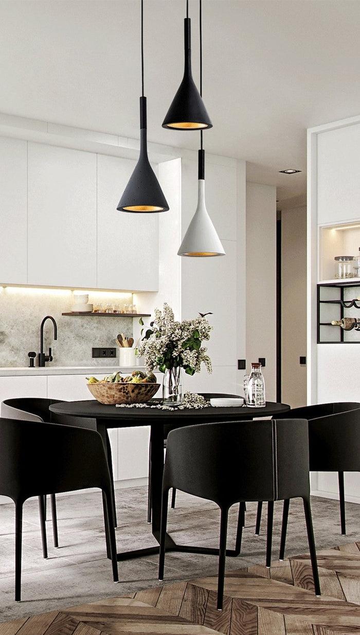 Scandinavian pendant lights installed above a contemporary Nordic-style dining area.