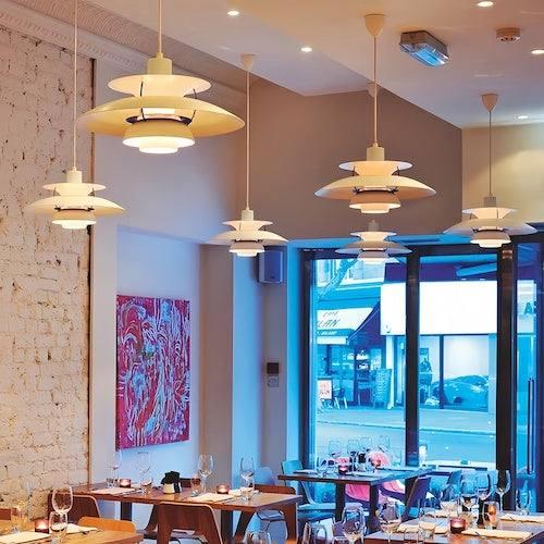 Scandinavian pendant lights installed above a contemporary Nordic-style dining area.