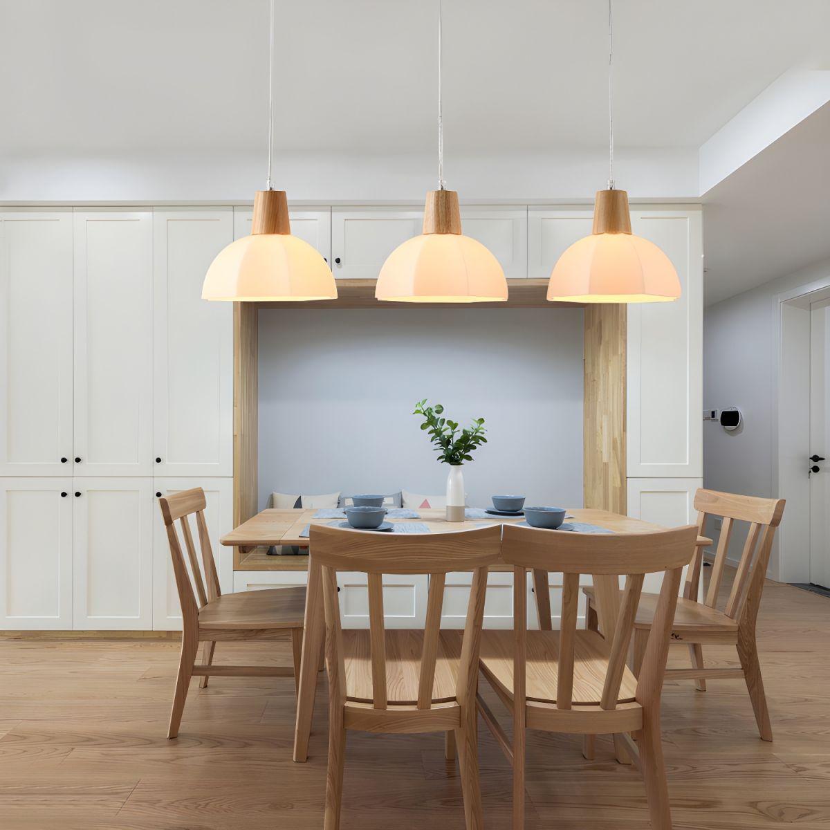 Scandinavian pendant lights installed above a contemporary Nordic-style dining area.