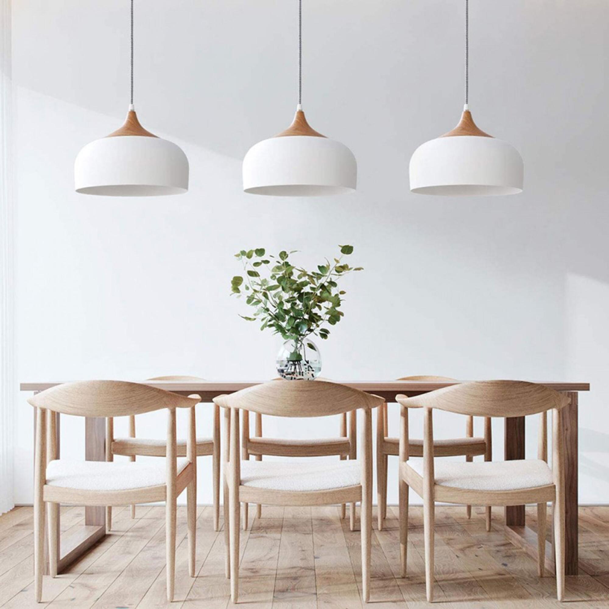 Scandinavian pendant lights installed above a contemporary Nordic-style dining area.