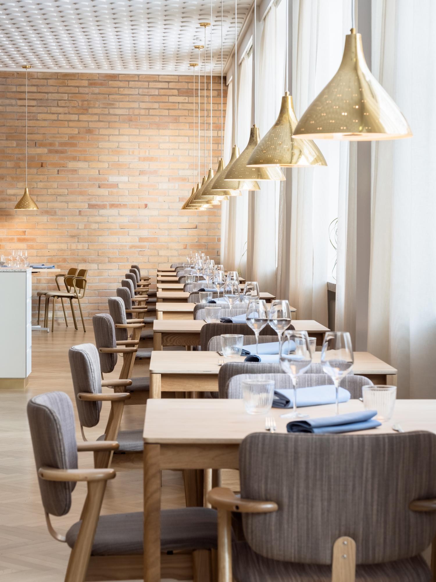 Scandinavian pendant lights installed above a contemporary Nordic-style dining area.
